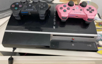 PS3 with 2 controllers, 2 games for sale