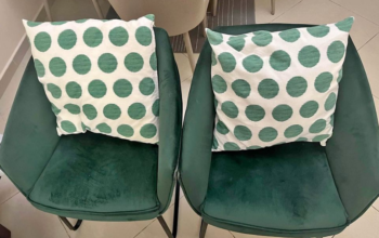 2 green chairs with throw pillows for sale