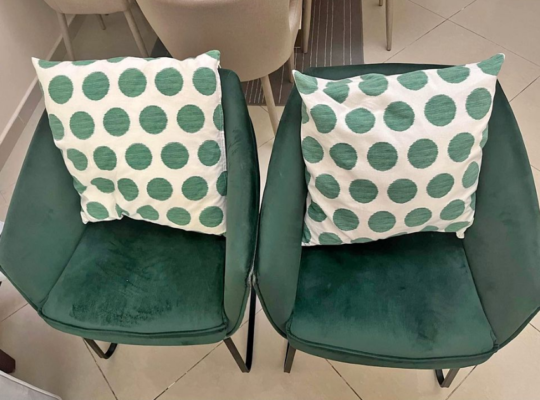 2 green chairs with throw pillows for sale