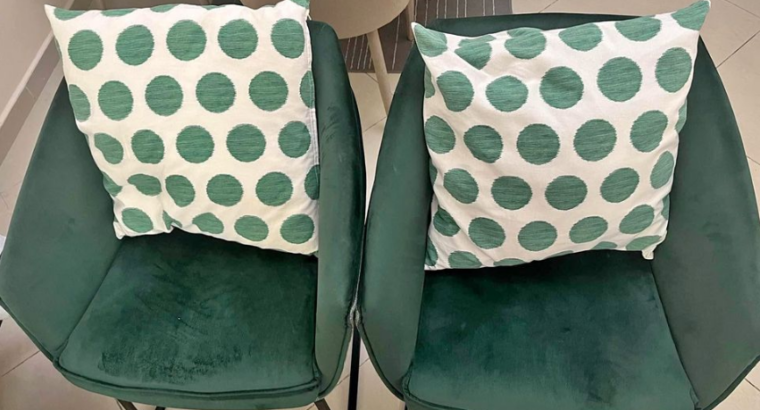 2 green chairs with throw pillows for sale